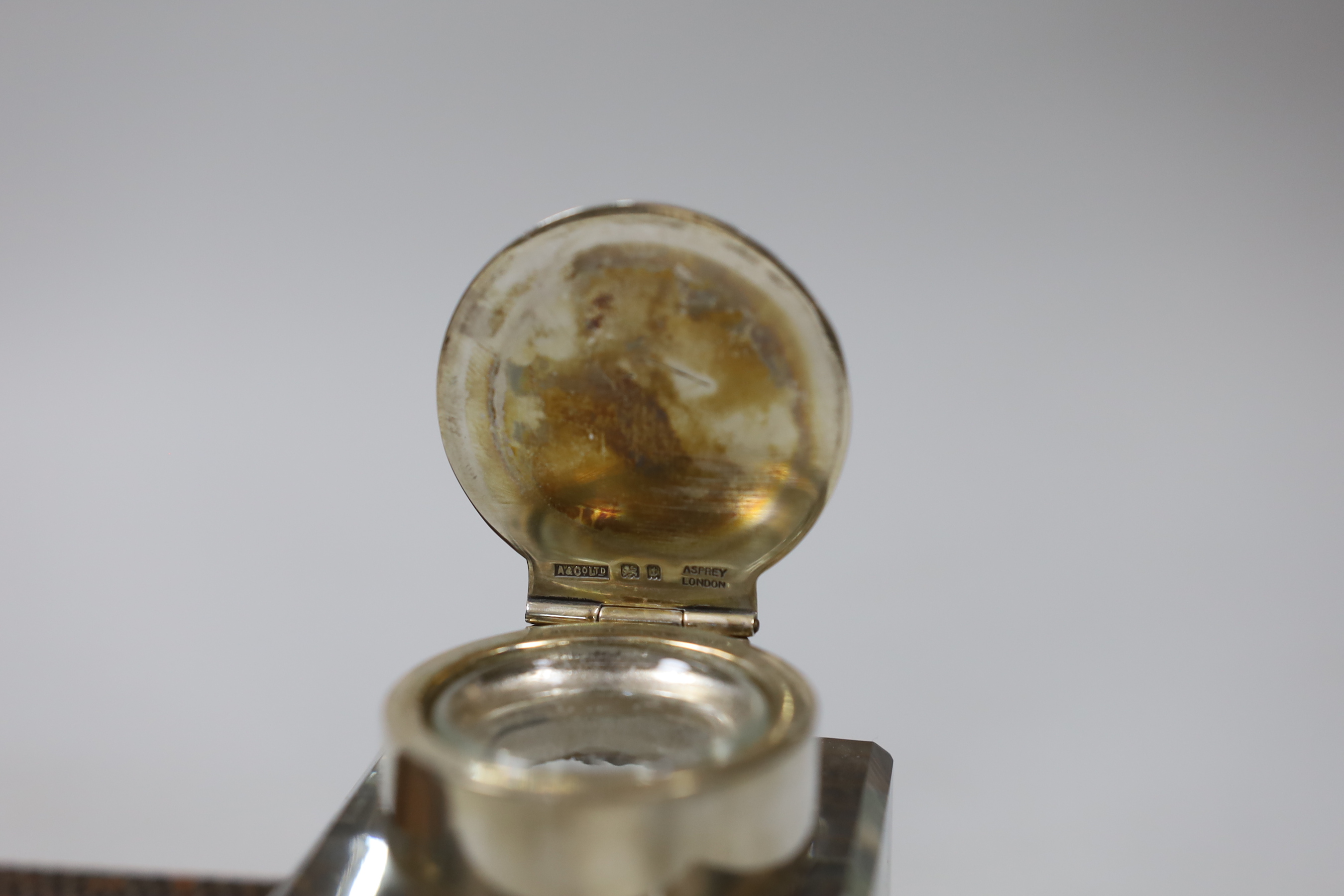 A George V Asprey & Co leather inkstand, with two mounted glass wells, Asprey & Co, London ,1934, length 38.2cm.